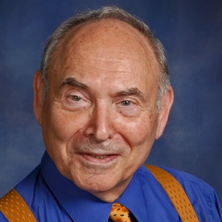 My late father, Maurice Zeldman, wearing a dark blue business shirt, a gaudy orange necktie, and equally gaudy orange suspenders.